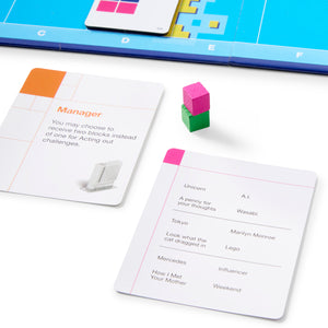Game cards with text and colorful blocks on a white surface