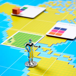Toy robot figure on a colorful grid map with color swatches in the background