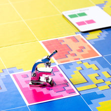 Load image into Gallery viewer, Small microscope on a colorful geometric patterned surface