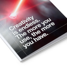 Load image into Gallery viewer, Book with a motivational quote on creativity, featuring a red light on a black cover.